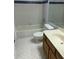 Bathroom with tub, toilet and wood vanity at 4119 Dijon Dr # 4119H, Orlando, FL 32808