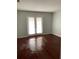 Bedroom with dark wood laminate flooring and French doors at 4119 Dijon Dr # 4119H, Orlando, FL 32808