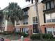 Exterior view of a two-story condo building with palm trees at 4119 Dijon Dr # 4119H, Orlando, FL 32808