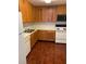 Kitchen with wood cabinets, laminate flooring, and appliances at 4119 Dijon Dr # 4119H, Orlando, FL 32808