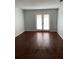 Living room with dark wood laminate flooring and French doors at 4119 Dijon Dr # 4119H, Orlando, FL 32808