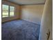 Simple bedroom with carpeted floor and large window at 4240 Fort Courage Cir, Kissimmee, FL 34746