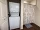 Compact laundry area with a stacked washer and dryer unit at 5364 Diplomat Ct # 106, Kissimmee, FL 34746