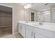 Bathroom with double vanity, walk-in shower, and access to a closet at 670 Summit River Dr, Apopka, FL 32712