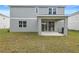 Rear view of house showing patio and grassy yard at 670 Summit River Dr, Apopka, FL 32712