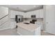 Modern kitchen with white cabinets, stainless steel appliances, and an island at 670 Summit River Dr, Apopka, FL 32712