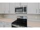 Stainless steel range and microwave installed above in a modern kitchen at 670 Summit River Dr, Apopka, FL 32712