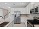 Modern kitchen with stainless steel appliances and white cabinets at 670 Summit River Dr, Apopka, FL 32712