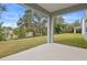 Covered patio overlooks grassy backyard and trees at 670 Summit River Dr, Apopka, FL 32712
