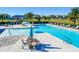 Community pool with a water feature and plenty of lounge chairs at 674 Anna Ridge Rd, Minneola, FL 34715