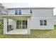 Rear view of house showing patio and landscaping at 680 Summit River Dr, Apopka, FL 32712