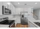 Modern kitchen with stainless steel appliances and white cabinets at 680 Summit River Dr, Apopka, FL 32712