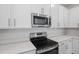 Stainless steel range and microwave in a modern kitchen at 680 Summit River Dr, Apopka, FL 32712