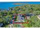 An aerial view showing a house near the lake with a large backyard and detached garage at 729 Main Street, Windermere, FL 34786