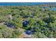 An aerial view showing a house near the lake with a pool and lush landscaping at 729 Main Street, Windermere, FL 34786