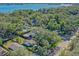 An aerial shot revealing a house with a pool, situated near a tranquil lake and surrounded by trees at 729 Main Street, Windermere, FL 34786