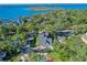 An aerial view of a house with a large backyard, detached garage, and a stunning lake view at 729 Main Street, Windermere, FL 34786