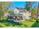Charming two-story home with a large front porch and lush lawn at 729 Main Street, Windermere, FL 34786