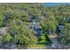 Aerial view of a house featuring a pool and lakefront views with mature trees at 729 Main Street, Windermere, FL 34786