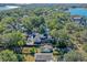 Aerial view showcasing a charming two-story house nestled amongst lush greenery near a lake at 729 Main Street, Windermere, FL 34786