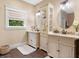 Elegant bathroom with double vanity, granite countertop, and decorative mirror at 729 Main Street, Windermere, FL 34786