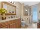 Elegant bathroom with wood vanity, large mirror and walk-in shower at 729 Main Street, Windermere, FL 34786