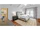 Spacious bedroom with vaulted ceiling, hardwood floors, and en-suite bathroom access at 729 Main Street, Windermere, FL 34786