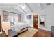 Large bedroom with hardwood floors, a walk-in closet, and a neutral color scheme at 729 Main Street, Windermere, FL 34786