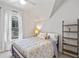 Bright bedroom featuring a metal bed frame and built-in shelving at 729 Main Street, Windermere, FL 34786