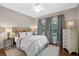 Comfortable guest bedroom with a queen-size bed and hardwood floors at 729 Main Street, Windermere, FL 34786