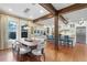 Open concept dining room with large wooden table and modern light fixture at 729 Main Street, Windermere, FL 34786