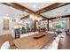 Bright dining room with a long wooden table and an open floor plan to the living room and kitchen at 729 Main Street, Windermere, FL 34786