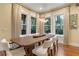 Elegant dining room with hardwood floors, large windows, and a wooden table at 729 Main Street, Windermere, FL 34786