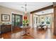 Bright and spacious entryway with hardwood floors, a large chandelier, and a view to the dining area at 729 Main Street, Windermere, FL 34786