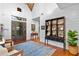Elegant entryway with hardwood floors, built-in shelving and a statement rug at 729 Main Street, Windermere, FL 34786