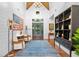 Spacious entryway with hardwood floors, a large bookcase and a blue rug at 729 Main Street, Windermere, FL 34786