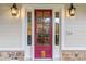 Charming red front door with sidelights, enhancing the home's curb appeal at 729 Main Street, Windermere, FL 34786