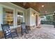 Relaxing front porch with rocking chairs and a view of the landscaped yard at 729 Main Street, Windermere, FL 34786