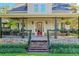 Inviting front porch with hanging plants and rocking chairs at 729 Main Street, Windermere, FL 34786