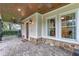 Inviting front porch with brick pavers, ceiling fan, and rocking chairs at 729 Main Street, Windermere, FL 34786
