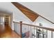 Upstairs hallway with hardwood floors, wooden ceiling detail, and a view of the entryway at 729 Main Street, Windermere, FL 34786