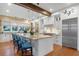 Modern kitchen with white cabinets, granite countertops, and stainless steel appliances at 729 Main Street, Windermere, FL 34786
