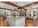 Large kitchen island with granite countertop, white cabinets, and a farmhouse style sink at 729 Main Street, Windermere, FL 34786