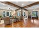 Open living room with hardwood floors, exposed beams, and comfortable seating at 729 Main Street, Windermere, FL 34786