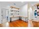 Home office with wood floors, industrial shelving and built-in desk at 729 Main Street, Windermere, FL 34786