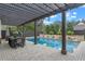Luxury pool with pergola, dining area, and stone accents at 729 Main Street, Windermere, FL 34786