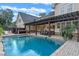 Resort-style pool with pergola, outdoor kitchen, and seating at 729 Main Street, Windermere, FL 34786