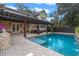 Stunning pool area with pergola, outdoor kitchen, and dining space at 729 Main Street, Windermere, FL 34786