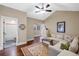 Relaxing sitting area with sectional sofa, hardwood floors and adjacent bathroom access at 729 Main Street, Windermere, FL 34786