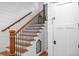 Modern staircase with wooden railings and a pet door at 729 Main Street, Windermere, FL 34786